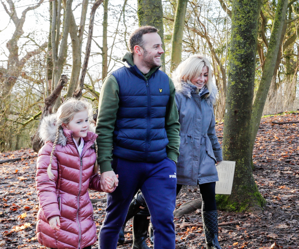 A family strolling through the woods at Mini Foresters